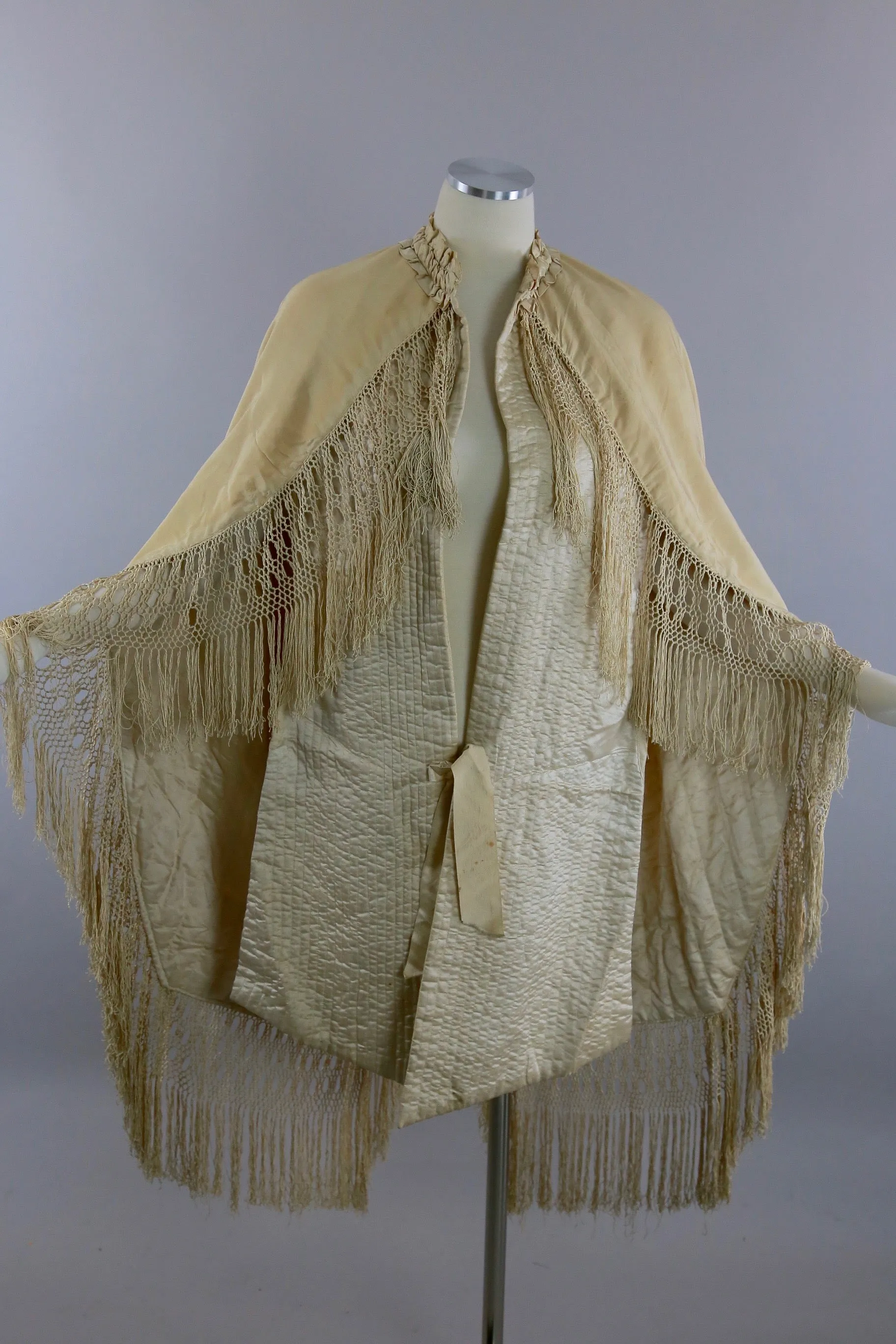 Antique Victorian ruched cape with quilted lining long hand knotted fringe trim